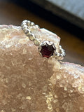 R26  SS 6mm Garnet bead wire size 7 ring